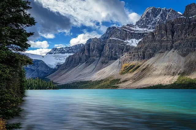 Stunning turquoise waters of Bow Lake in the Canadian Rockies with mountain backdrop